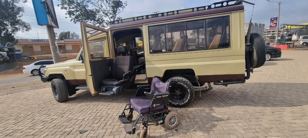 Wheelchair accessible 4x4 Land Cruiser with hydraulic lift and pop-up roof at Mara River crossing during Great Migration